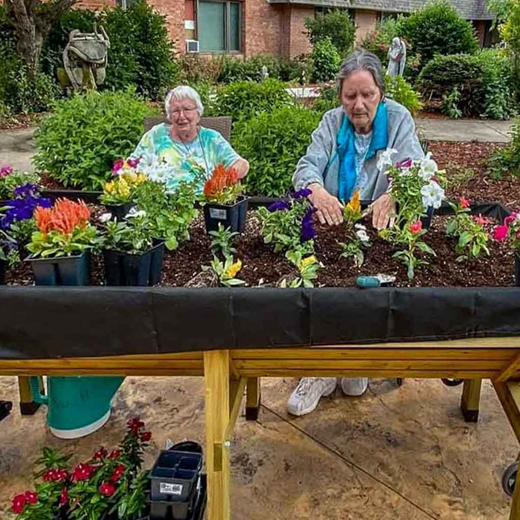 Residents and Volunteers Planting Flowers
